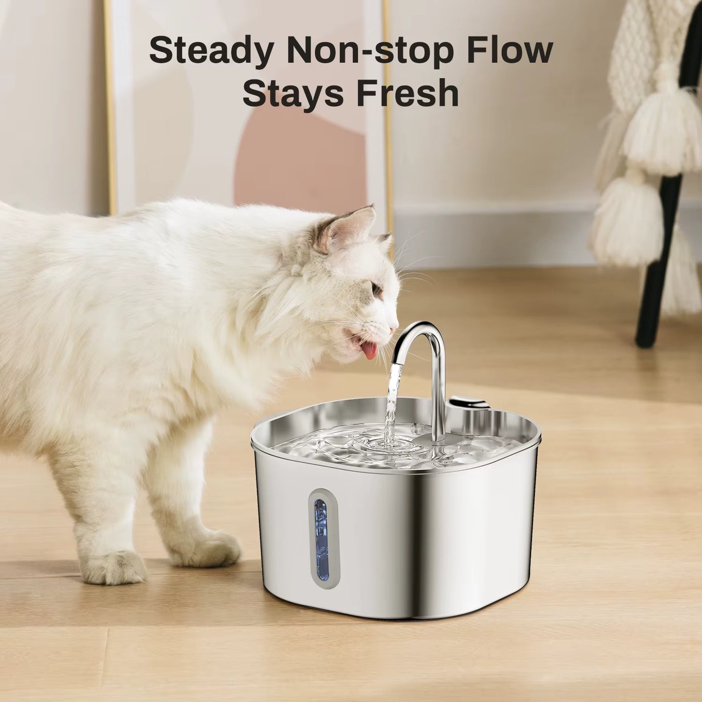 Cat drinking water from a stainless steel pet fountain on a wooden floor.