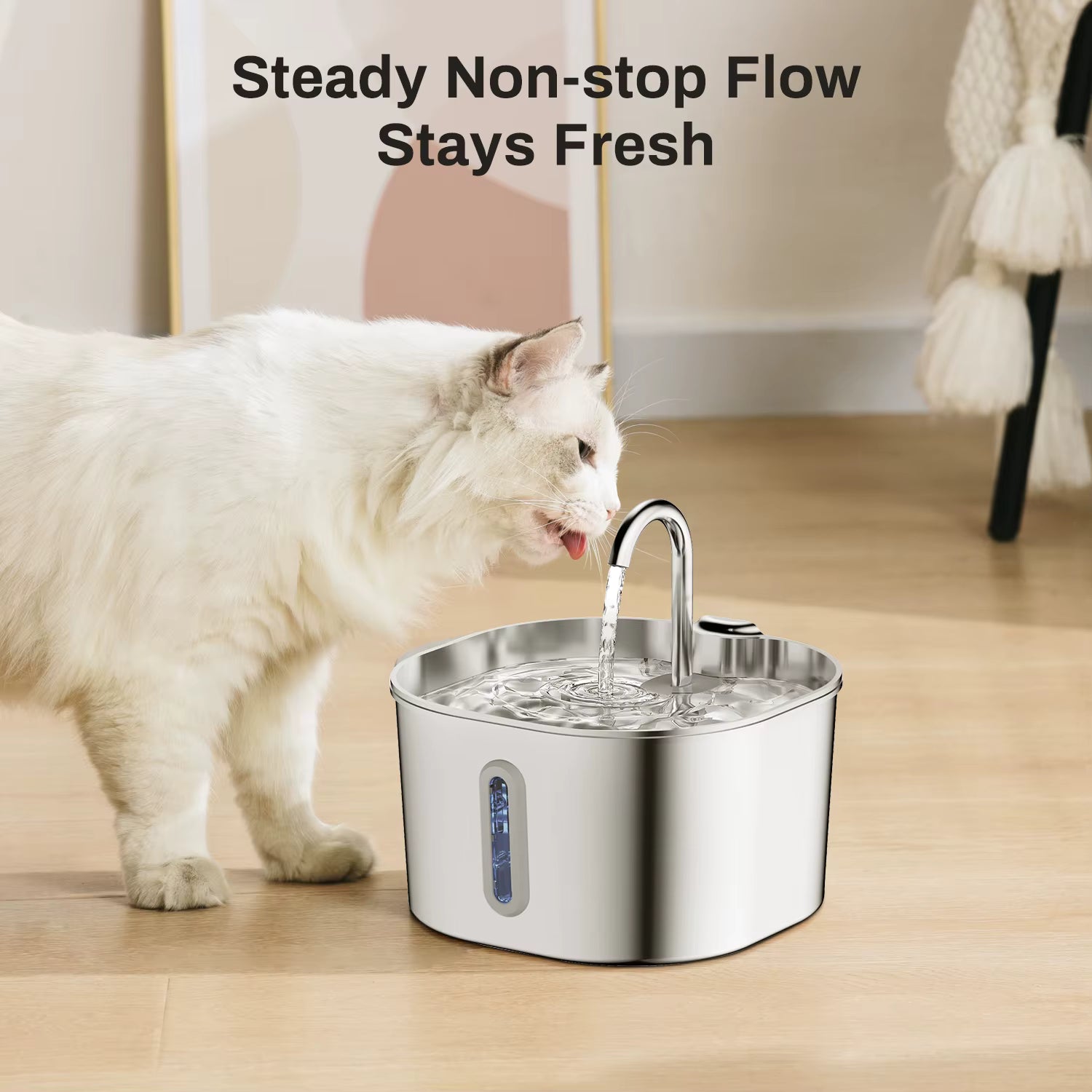 Cat drinking water from a stainless steel pet fountain on a wooden floor.